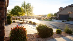 A suburban street with a driveway leading to a house with a garage. - SPOTLESS,Booking for SUMMER FALL AND WINTER 3bdrm 2bth ONE LEVEL Great location! (Washington)