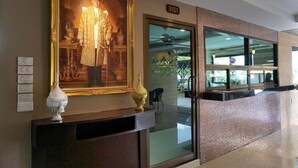 A reception area with a large framed portrait, a decorative vase, and a number sign '3101'.