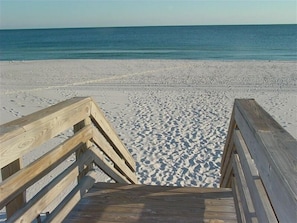 A wooden boardwalk leading to a sandy beach with a calm sea in the background. - Beautiful Condo, Great View and Rates, Easy Internet Access (Gulf Shores)