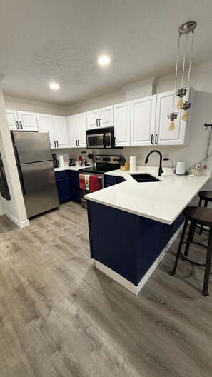 Fridge, microwave, stovetop, coffee/tea maker