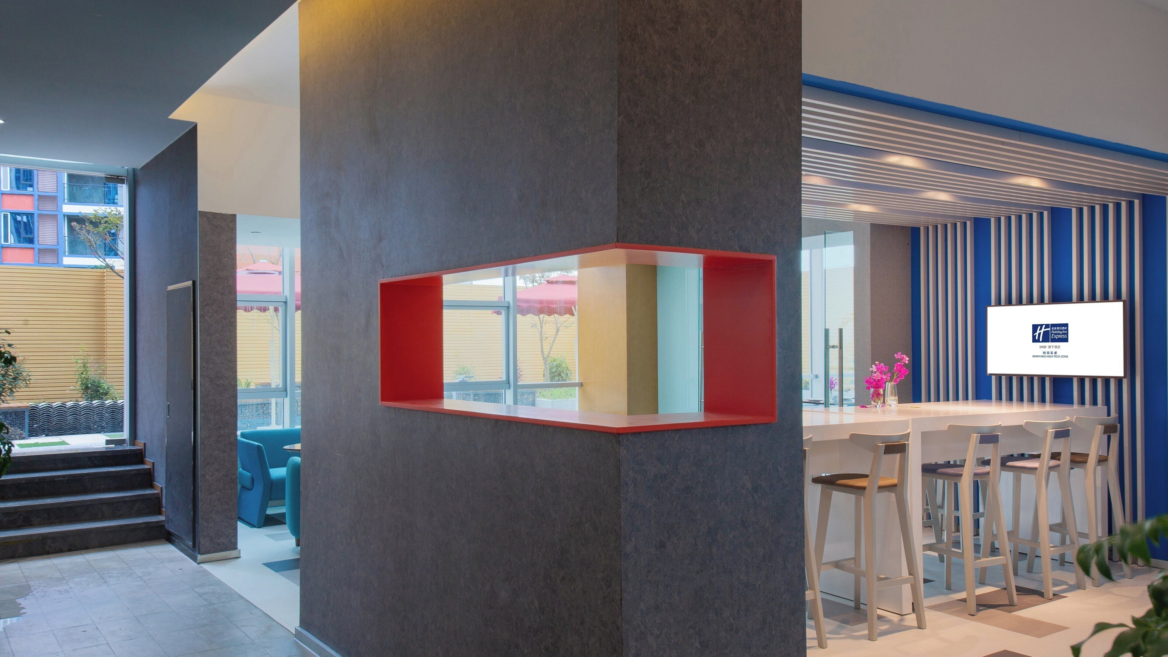 A modern interior with a bar area, a seating arrangement, and a large window.
