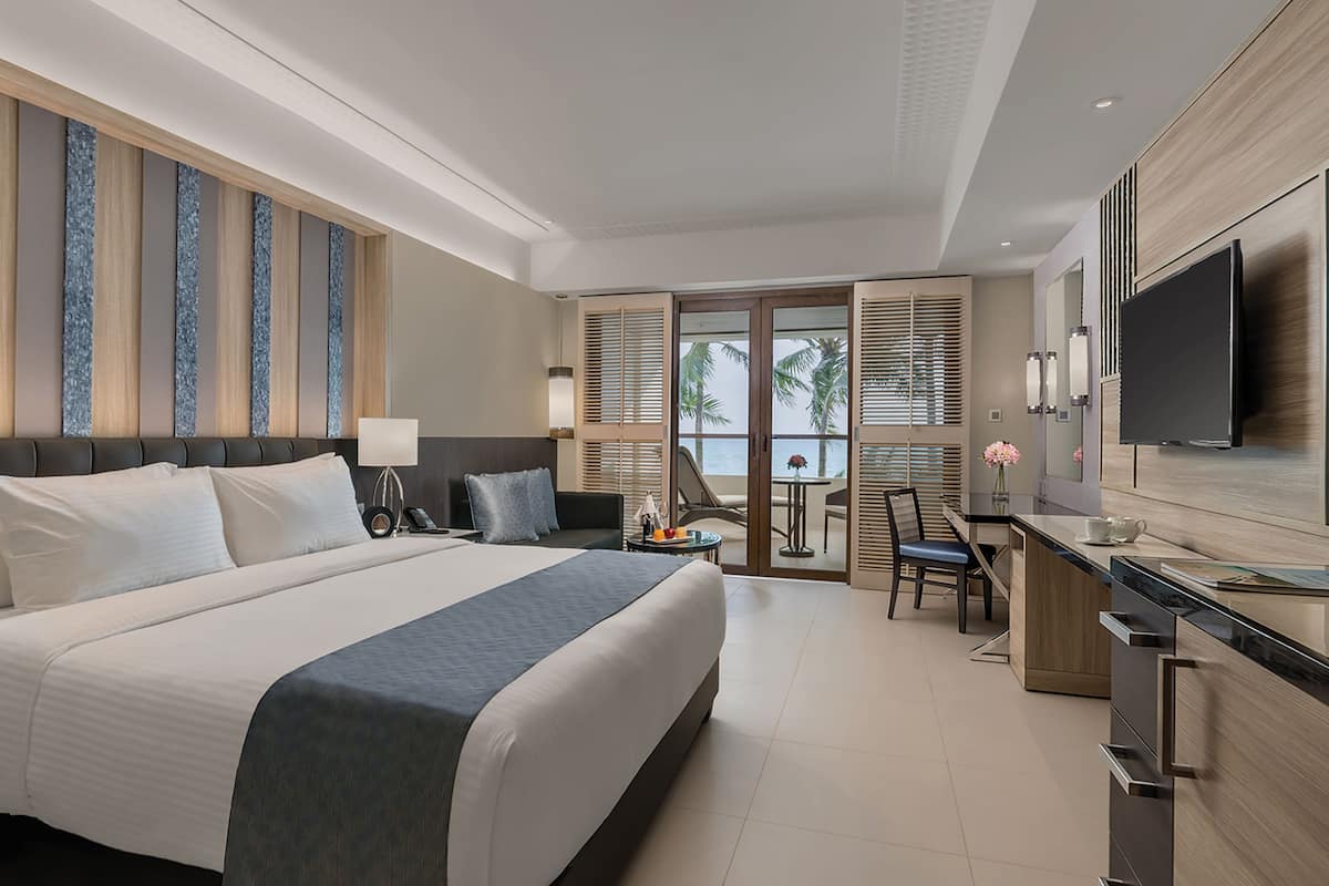 grand room, beach view | minibar, in-room safe, desk, iron/ironing board