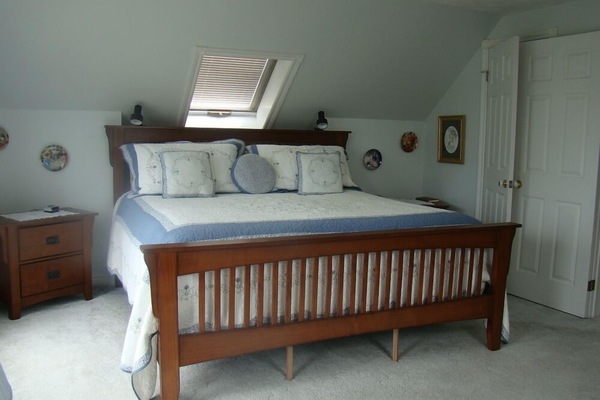 The master bedroom has a king size bed and a private deck with a beautiful view of the water.