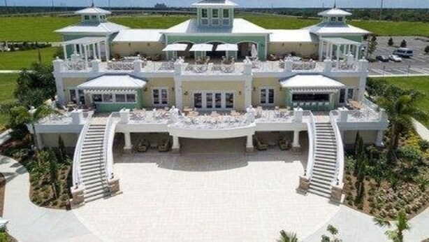 A large, multi-story hotel with a central courtyard, multiple balconies, and a prominent tower. - Free Shuttle,Official Encore Water Park,XBOX,Movie,Games,Cage,Pool/Spa,Star Wars (Kissimmee)