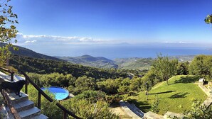 A view of a mountainous landscape with a clear sky, a swimming pool, and a stone staircase. - PELION HOMES | Villa SELINI large traditional villa w/ pool & breathtaking view (Agios Georgios Nilias)