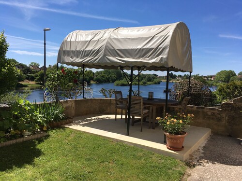 Glorious riverside town apartment with private garden overlooking La Dordogne . 