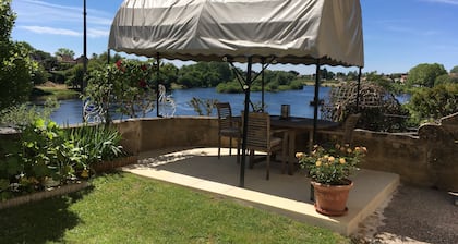 Glorious riverside town apartment with private garden overlooking La Dordogne .