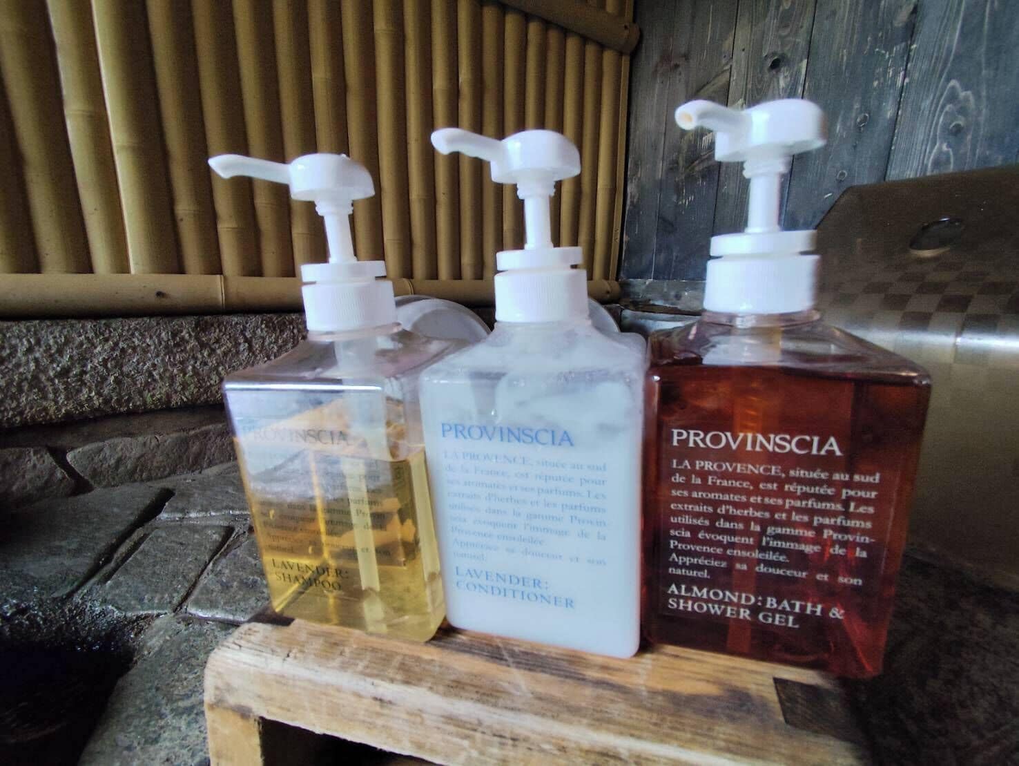 Three Provinscia bottles on a wooden surface.