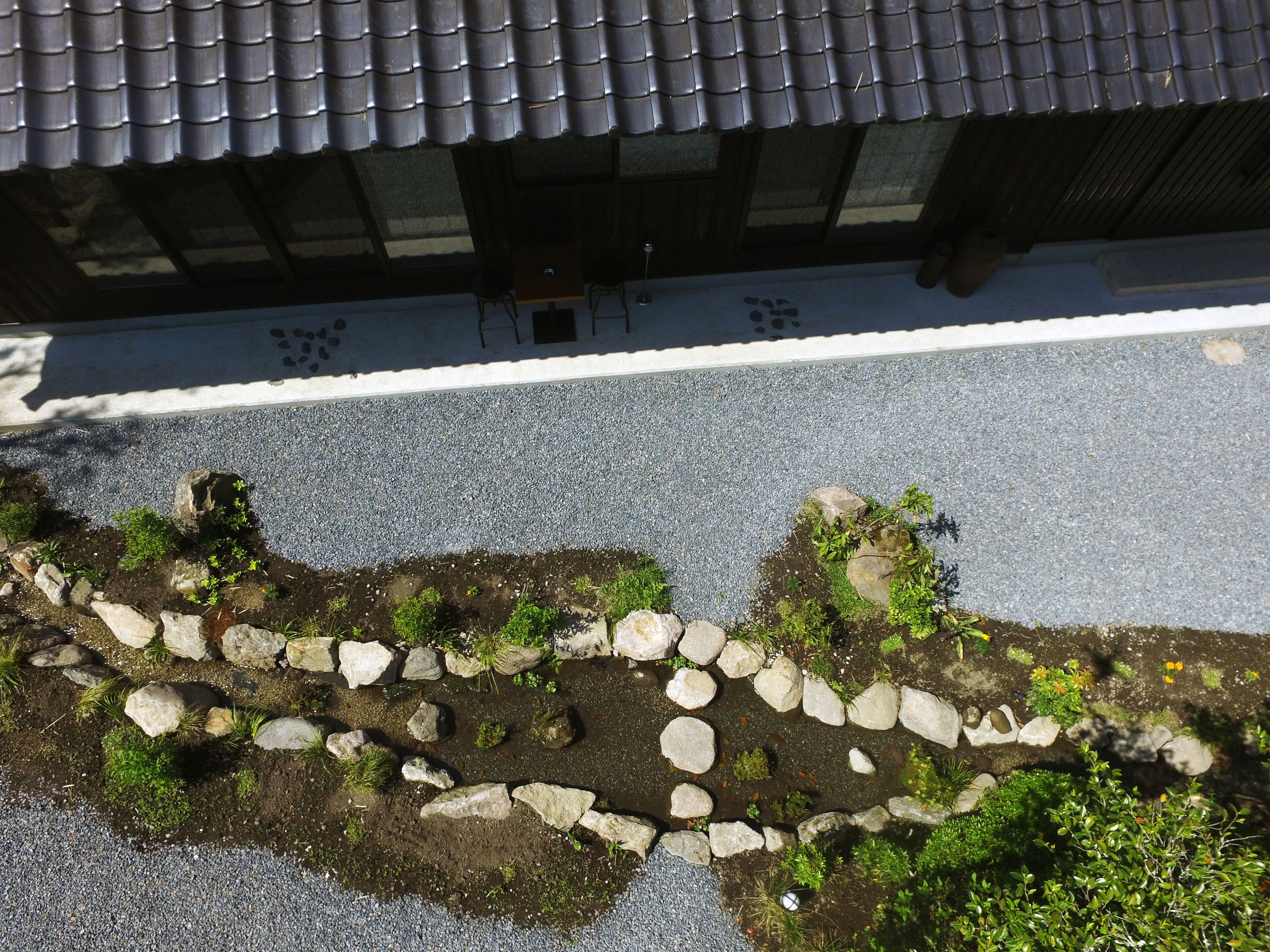 A traditional Japanese building with a tiled roof and a stone pathway leading to the entrance.