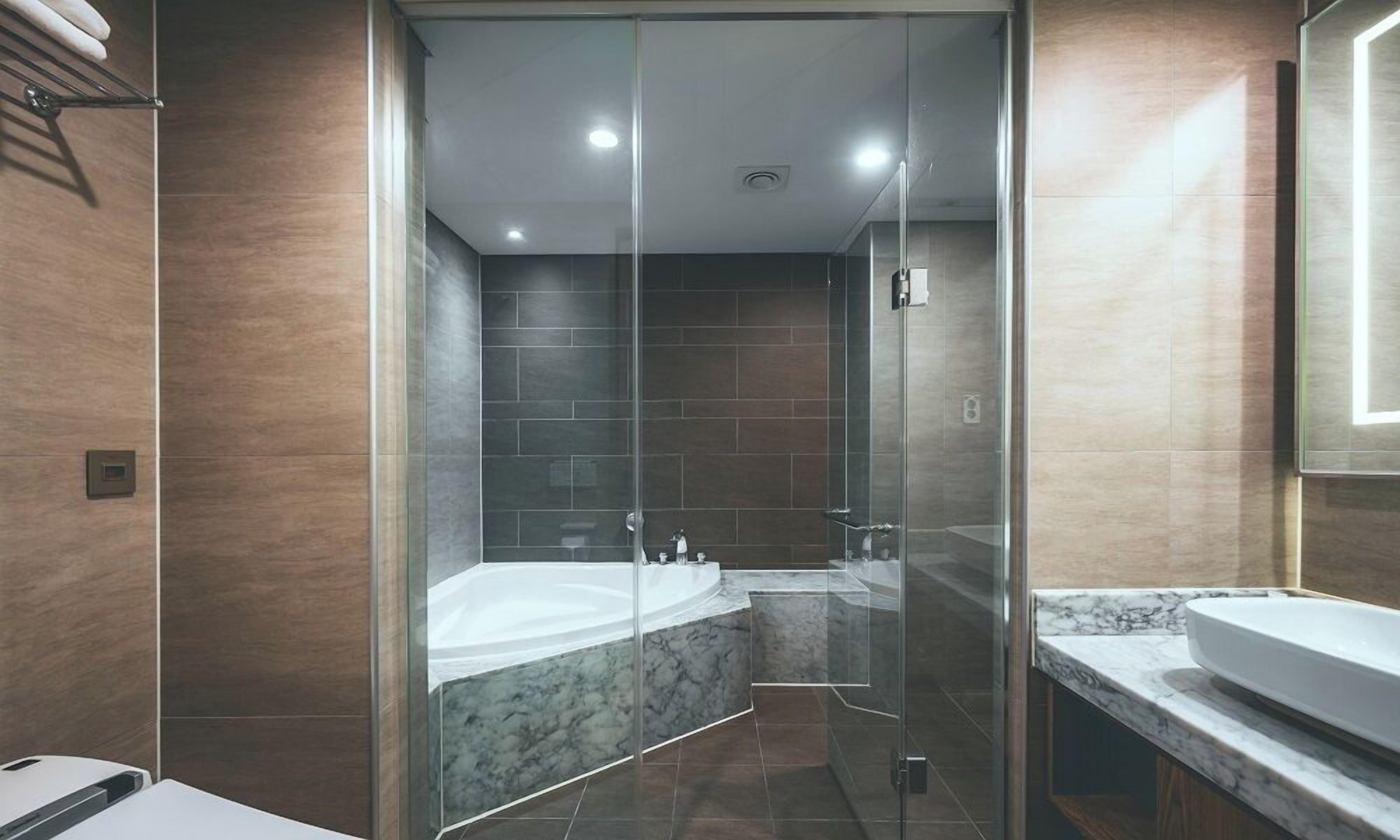 deluxe twin room | bathroom | shower, free toiletries, hair dryer, bathrobes