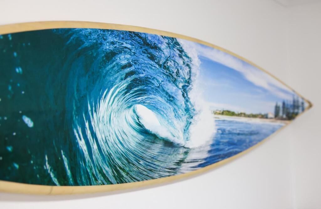 A surfboard with a wave design.