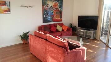 Deluxe Apartment, 2 Bedrooms | Living room | Flat-screen TV, DVD player