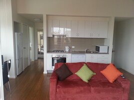 Deluxe Apartment, 2 Bedrooms | Living room | Flat-screen TV, DVD player