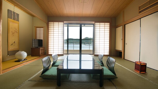 A traditional Japanese room with tatami flooring, a low wooden table, and shoji screens. - Kaisen no Yado Matsuura (Saiki)