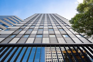 A high-rise building with a grid of windows and a modern architectural design.