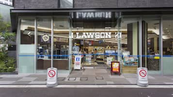 A Lawson store with a glass facade, visible signage, and a no-parking sign.