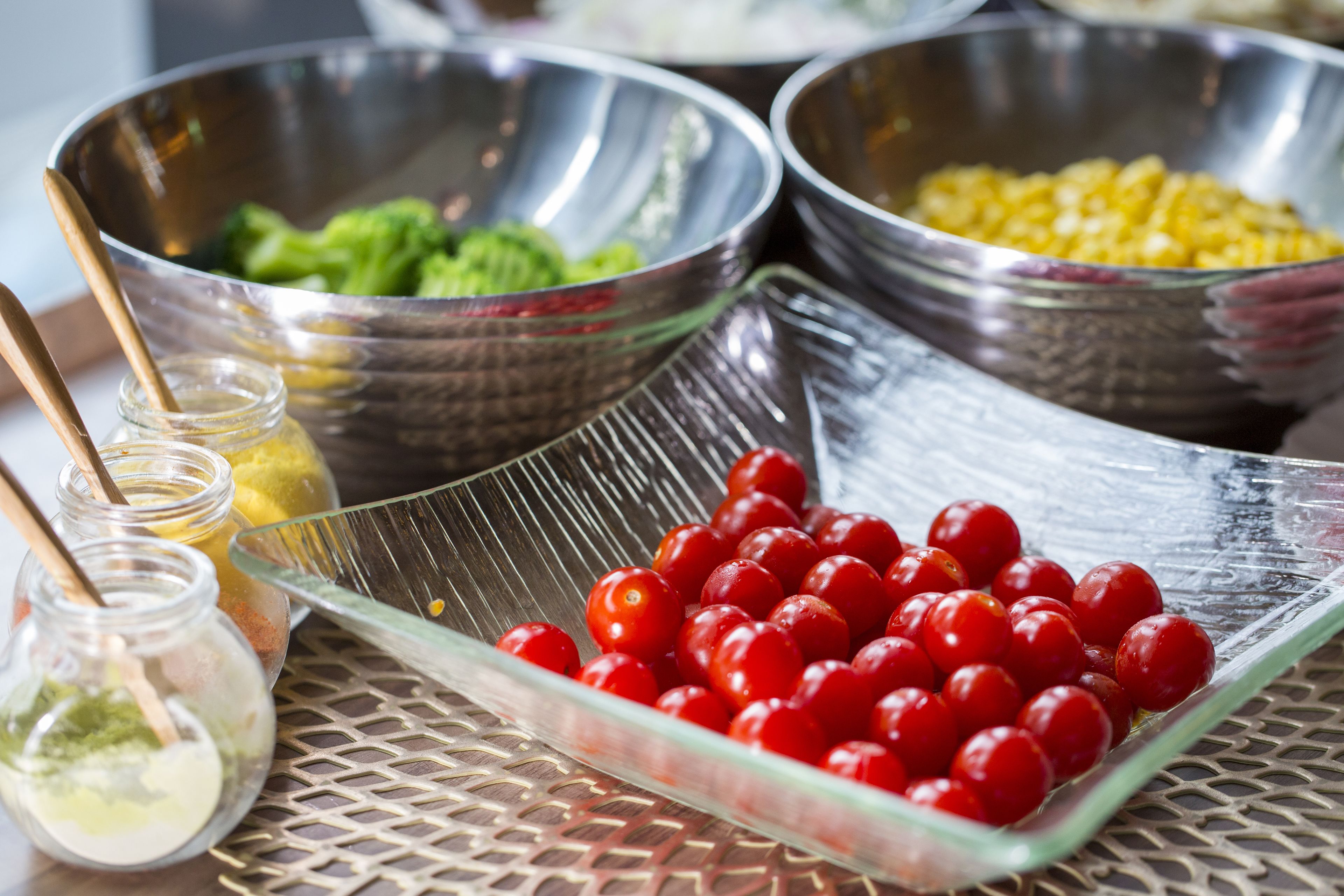 A table with various food items in bowls and a glass dish.