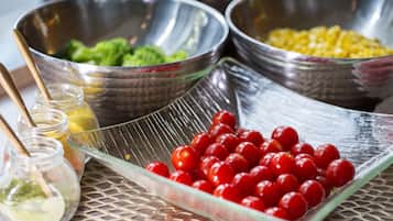 A table with various food items in bowls and a glass dish.