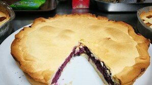 A pie with a slice missing, placed on a white plate. - Osteria Dei Locandieri (Abbadia San Salvatore)