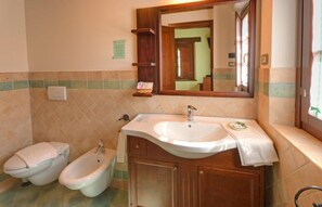 A bathroom with a sink, two bidets, and a mirror. - Agriturismo Le Bucoliche (Osimo)