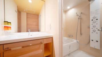 Une salle de bain moderne avec un double vasque, un meuble-lavabo en bois, une douche dotée de plusieurs commandes et une baignoire.