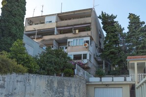 A multi-story residential building with balconies, satellite dishes, and a white fence. - Amazing Apartments near Center & Beaches (Split)