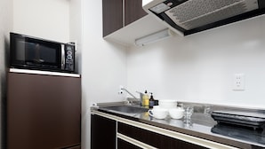 A compact kitchen with a microwave, refrigerator, and a sink. - The One Osaka Nipponbashi East (Osaka)