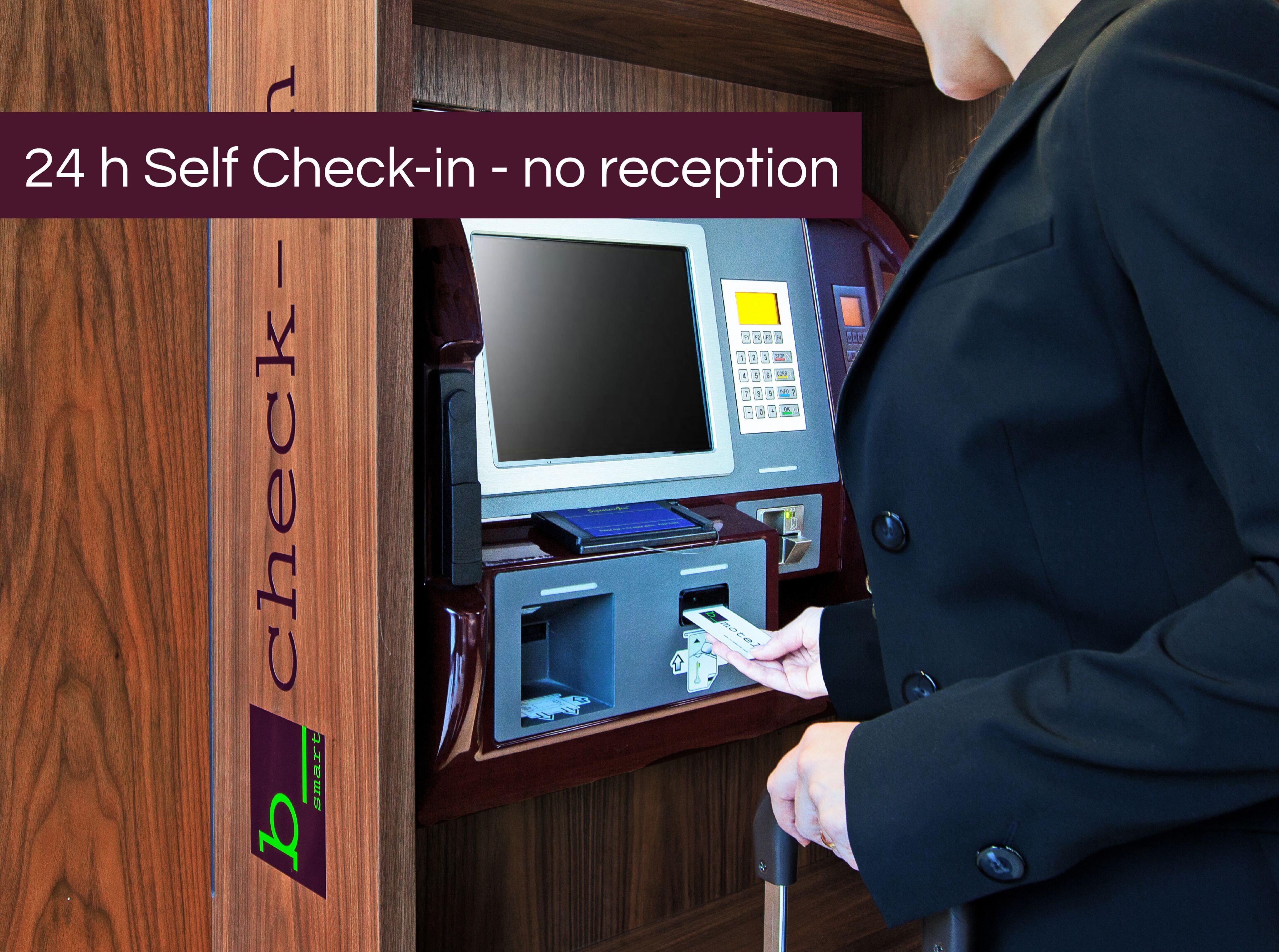 A self-check-in kiosk with a monitor, keypad, and card reader.