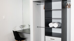 A modern room with a desk, chair, and built-in wardrobe with shelves and drawers. - Zeederberg Corner (Paarl)