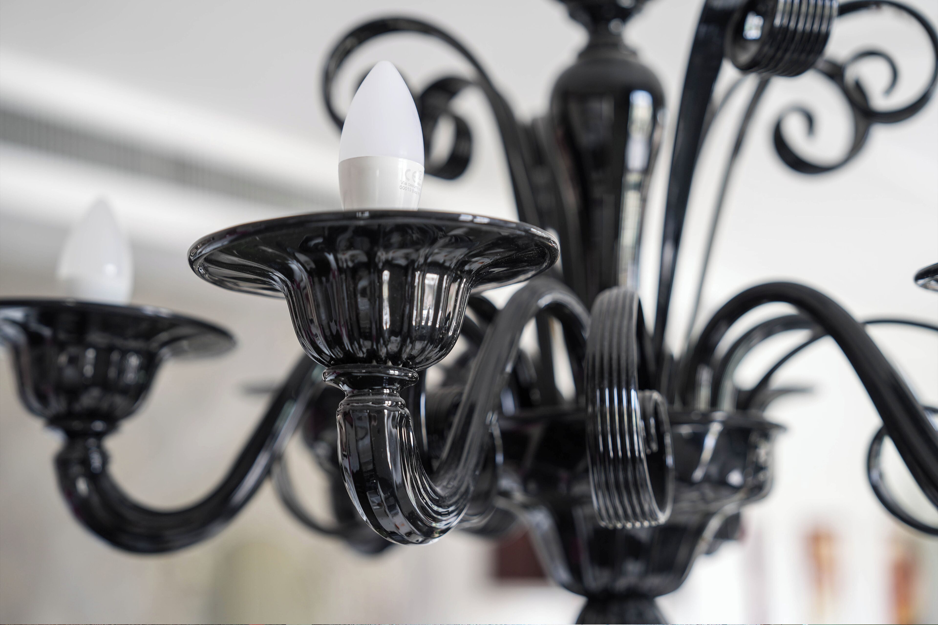 A chandelier with multiple arms and candle-like fixtures.