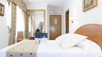 Triple Room - 2 Adults, 1 Child | Minibar, in-room safe, desk, blackout drapes