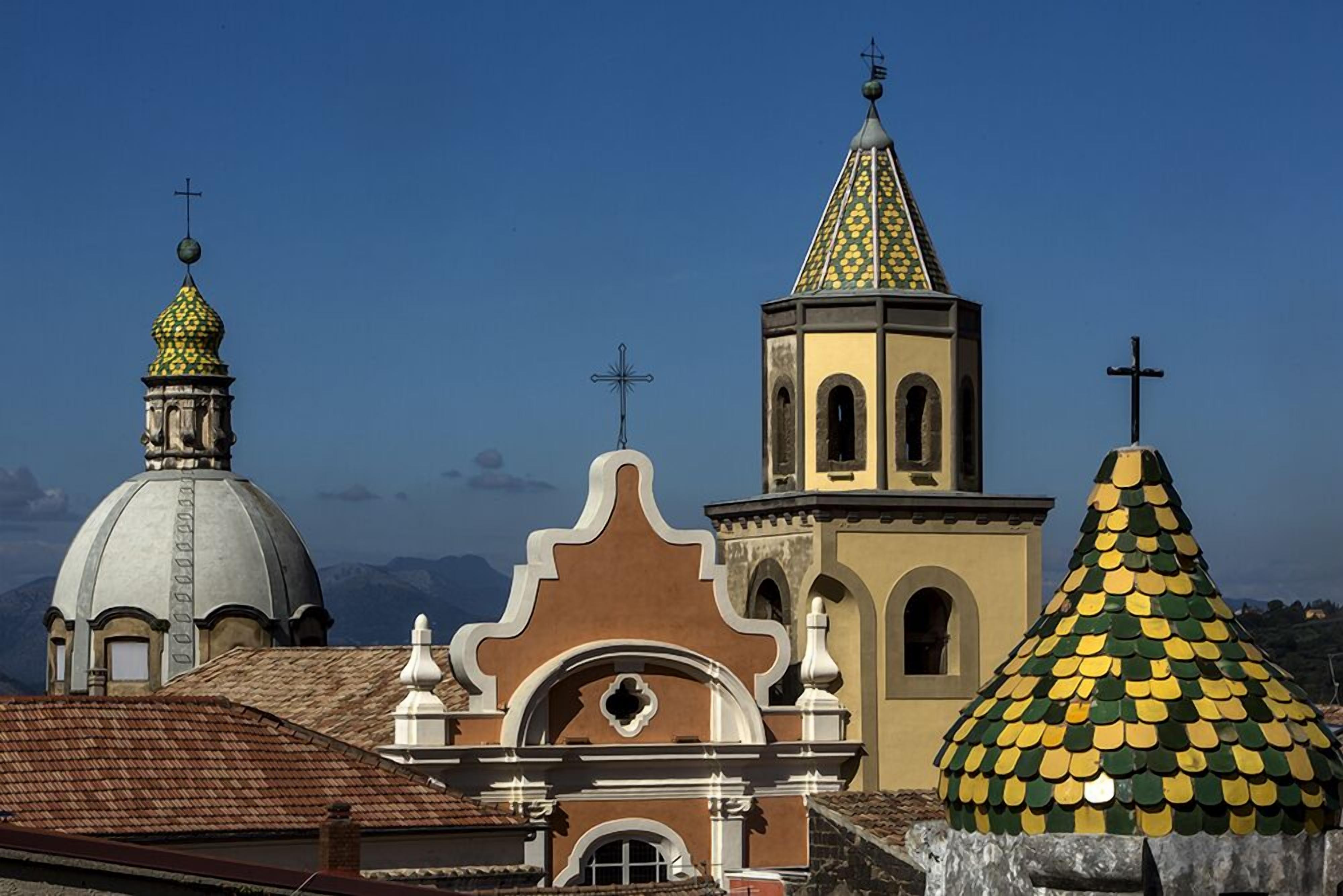 A church with a dome, bell tower, and a pointed roof.