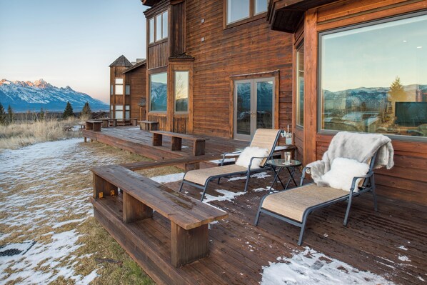 A wooden deck with outdoor seating and a mountain view. - Outpost: Spirit Dance 3110 - Summer Pool Access! (Jackson)