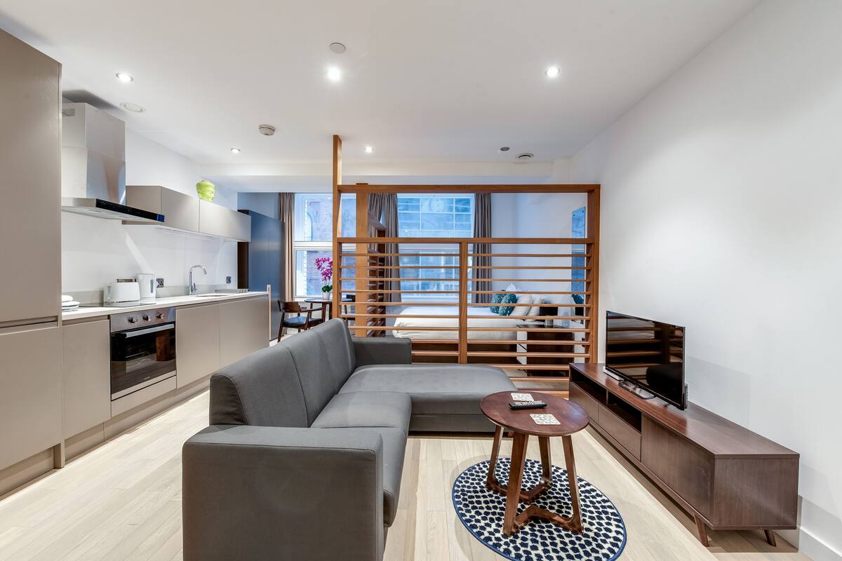 A modern apartment with a kitchen, living area, and a balcony.