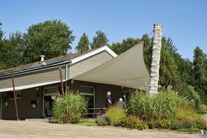 A building with a covered patio area, a chimney, and a sign that reads "BISTRO".