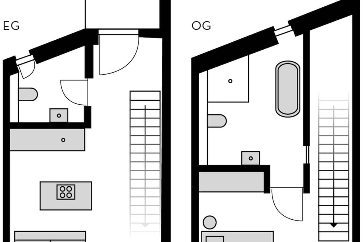 En planritning över ett hotell med två rum, märkta med ”EG” och ”OG”. Varje rum har ett badrum, en säng och ett skrivbord. Rummet märkt ”EG” har ett fönster med utsikt över utsidan, medan rummet märkt ”OG” har utsikt över interiören. Båda rummen har en dörr som leder ut till en hall.