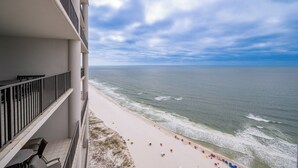 A beach view from a balcony with a railing, a sandy beach, and the ocean. - The Oasis at Orange Beach, formerly known as Phoenix West II, Unit 2609 (Orange Beach)