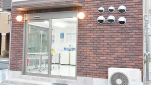 A building entrance with a glass door, a brick wall, and six security cameras. - The Wonder At Stay-Tengachaya- (Osaka)