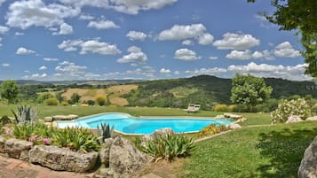 Seasonal outdoor pool, a natural pool, pool loungers