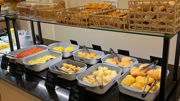 A buffet with various food items and labels in a hotel setting.