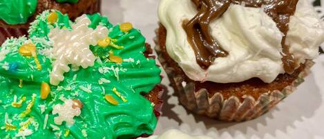 A variety of cupcakes with different frostings and decorations.