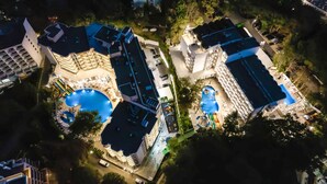 A large hotel complex with multiple swimming pools, a children's play area, and a variety of outdoor seating areas. - Prestige Deluxe Hotel & Aquapark Club - All Inclusive (Golden Sands)