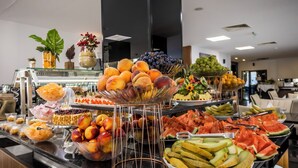 A buffet with various fruits and vegetables, including peaches, grapes, watermelon, and cucumbers. - Prestige Deluxe Hotel & Aquapark Club - All Inclusive (Golden Sands)