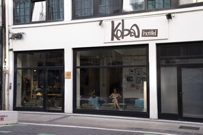 A hostel with large windows and a sign that reads "Kopa hostel". - Koba Hostel (San Sebastián)
