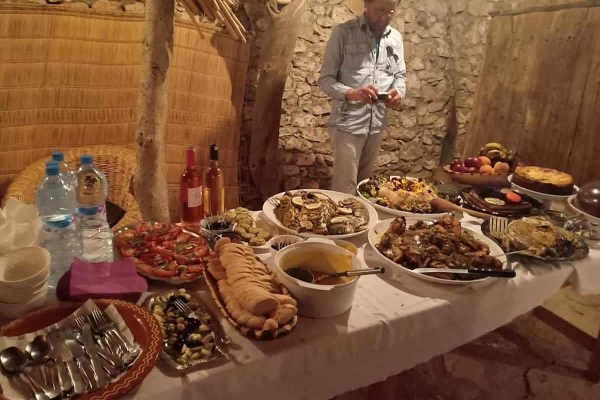 A table set with various dishes and bottles, likely for a meal.