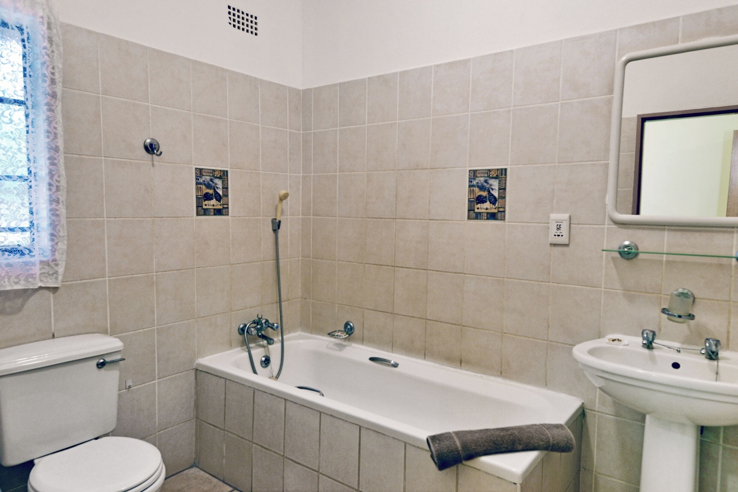 A bathroom with a toilet, bathtub, and sink.