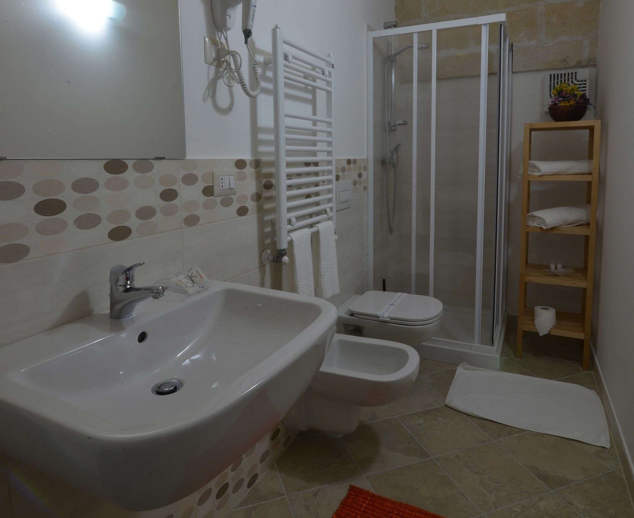 A bathroom with a sink, toilet, and shower.