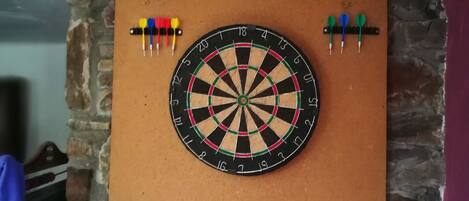 A dartboard mounted on a stone wall.