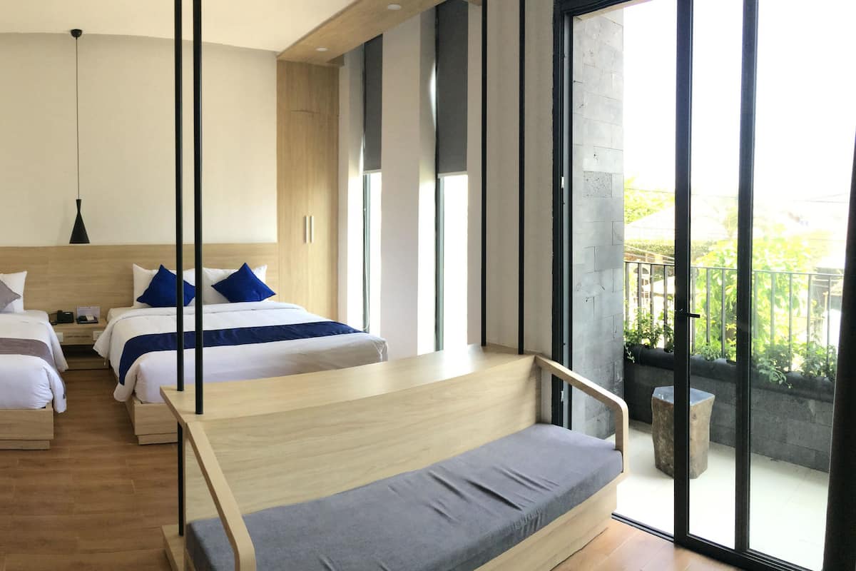 A modern hotel room with two beds, a balcony, and large windows.