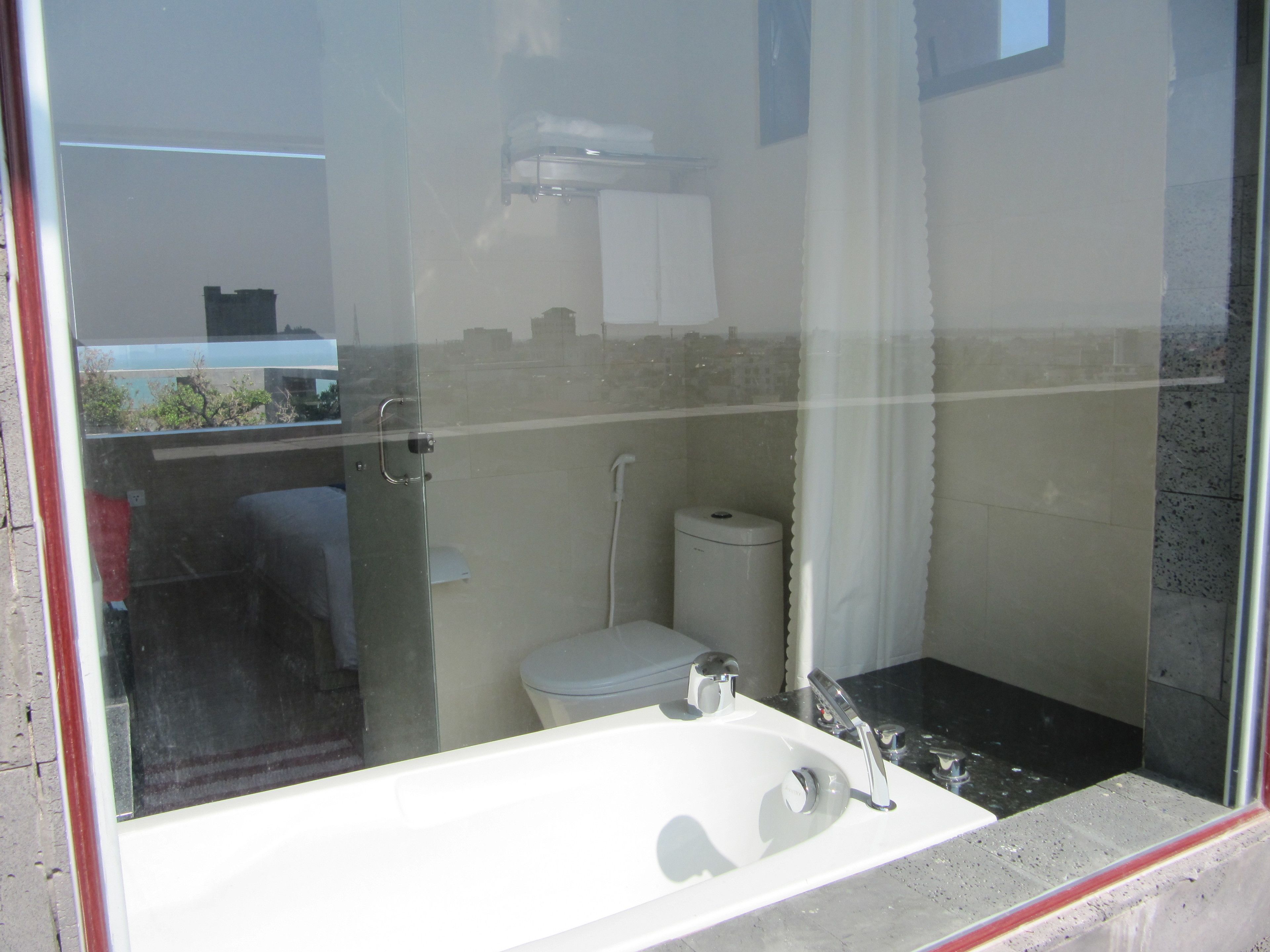 A bathroom with a white sink, a toilet, and a shower.